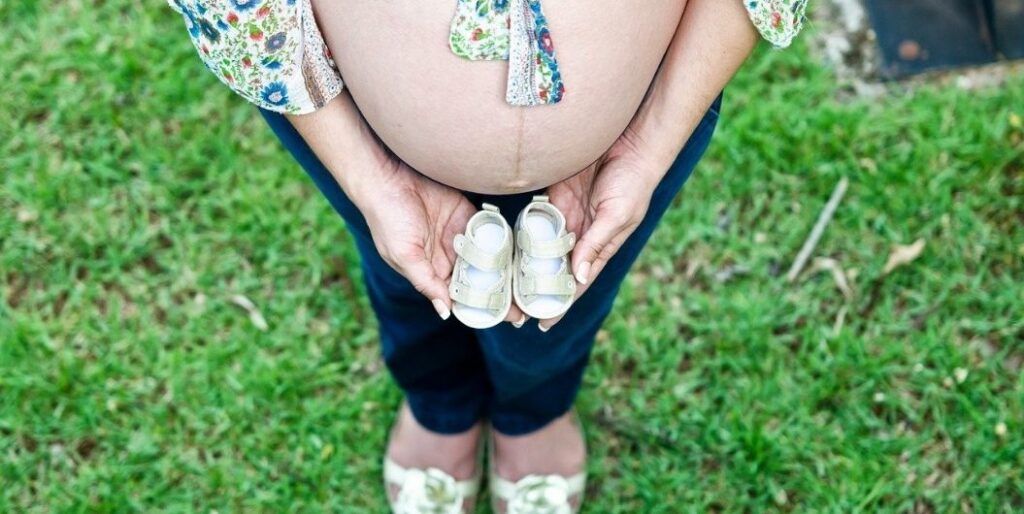 pregnant woman with little shoes